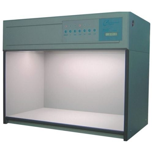 Technician inspecting a color assessment cabinet used for visual color evaluation